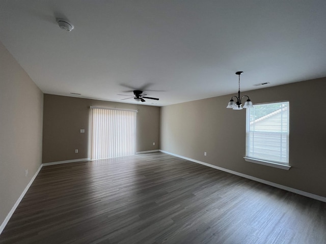 unfurnished room featuring dark wood-style floors, visible vents, and baseboards