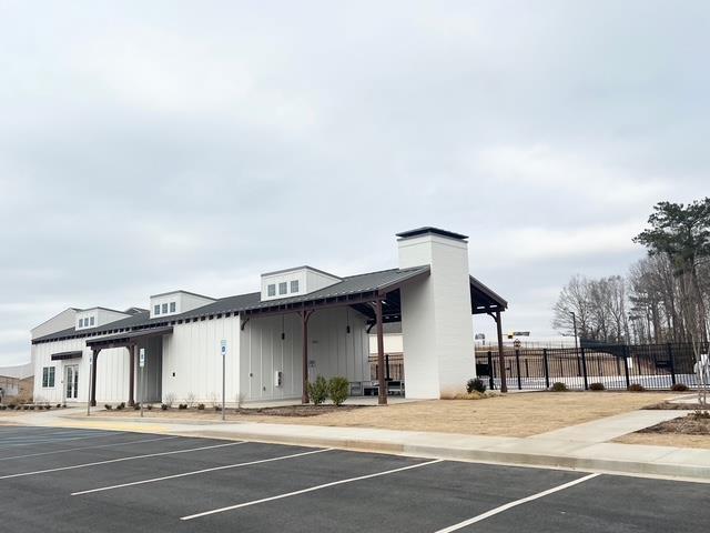 view of property featuring uncovered parking and fence