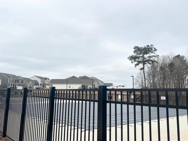 view of gate featuring a residential view and fence
