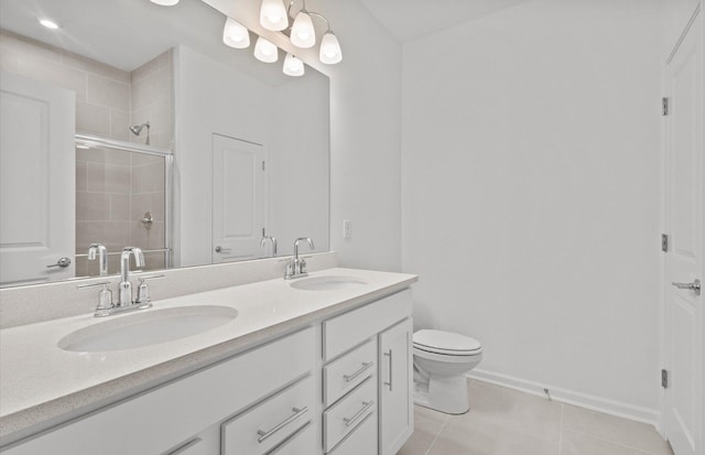 full bathroom featuring double vanity, a sink, a tile shower, and tile patterned floors