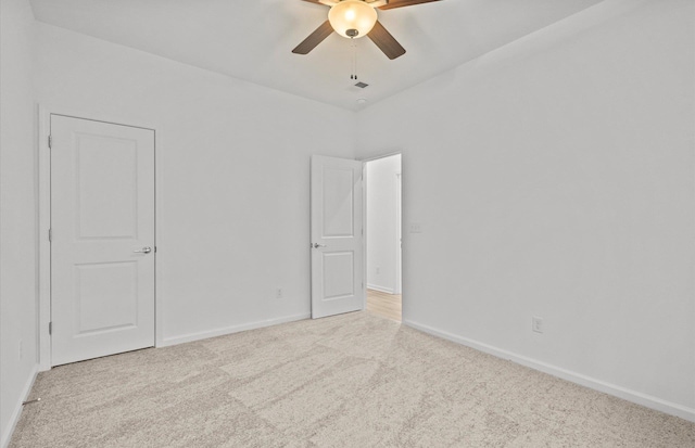 unfurnished room featuring light carpet, ceiling fan, visible vents, and baseboards