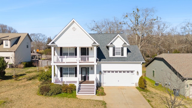 view of front of house featuring concrete driveway, a balcony, an attached garage, covered porch, and a front yard