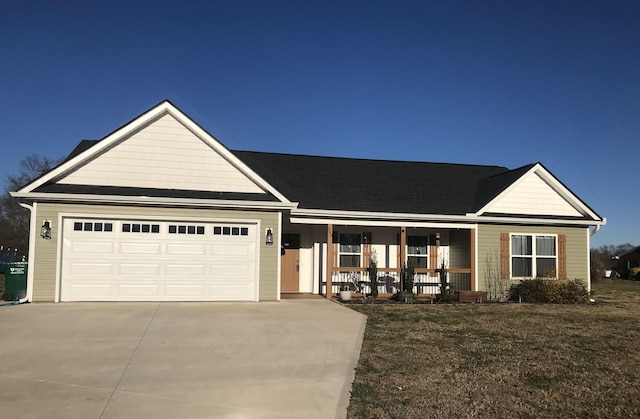 single story home with a garage, concrete driveway, a porch, and a front lawn