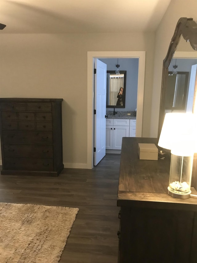 hall featuring dark wood-style floors and baseboards