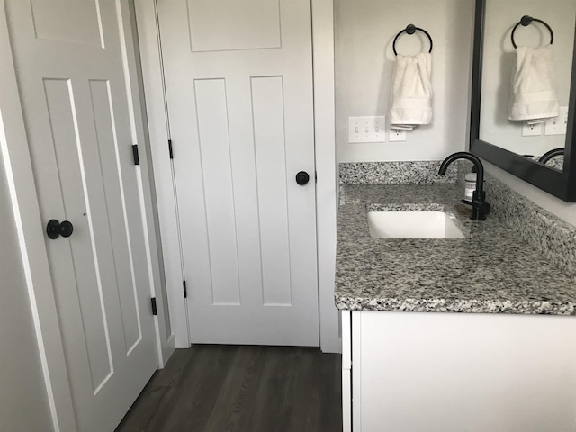 bathroom with vanity and wood finished floors