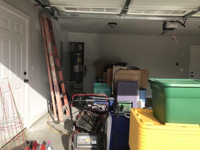 garage with a garage door opener and water heater