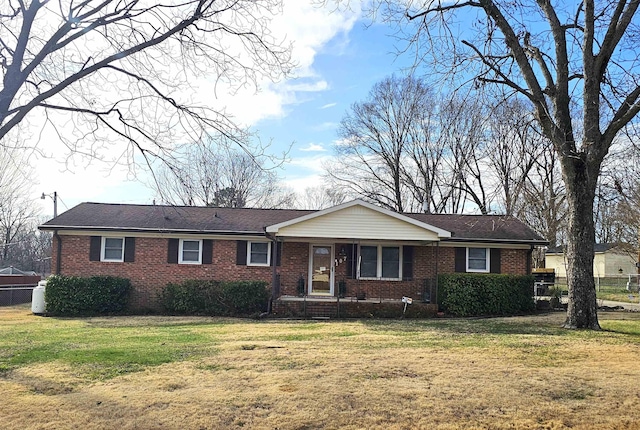 single story home with brick siding and a front yard