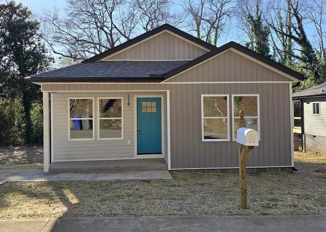 bungalow-style home featuring roof with shingles