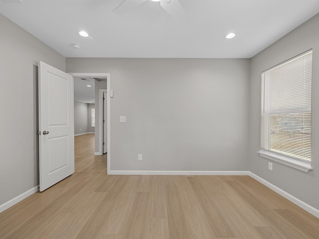 empty room with ceiling fan, recessed lighting, light wood-style flooring, and baseboards