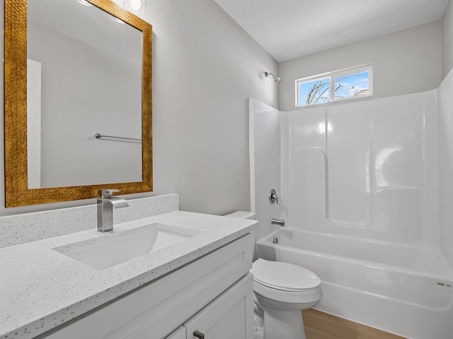 bathroom featuring shower / bath combination, vanity, toilet, and wood finished floors