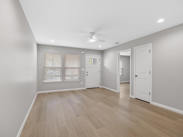 interior space with a ceiling fan, recessed lighting, baseboards, and light wood finished floors