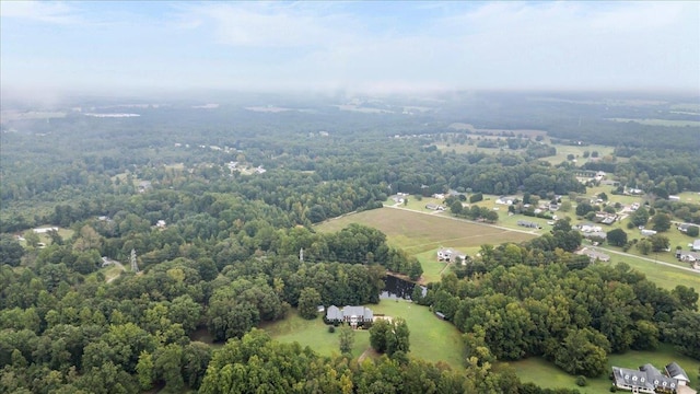 bird's eye view featuring a wooded view