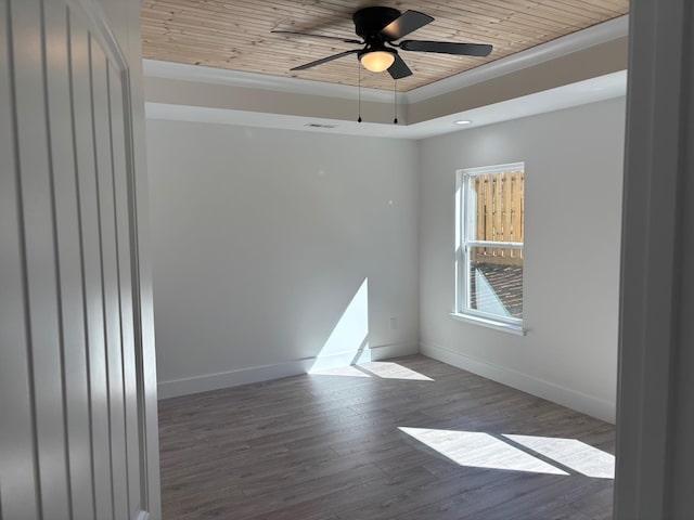 empty room featuring visible vents, baseboards, a raised ceiling, wood ceiling, and wood finished floors