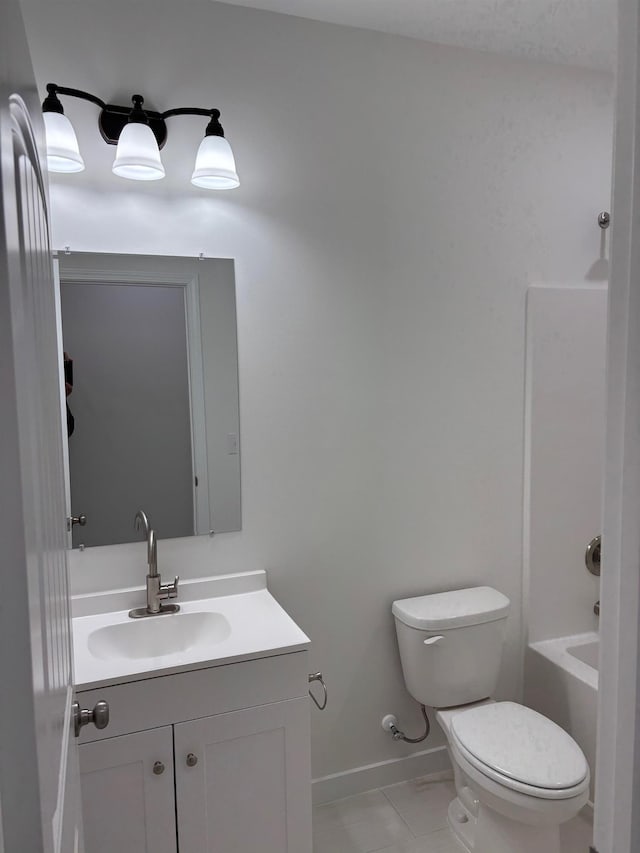 full bathroom with toilet, vanity, and baseboards