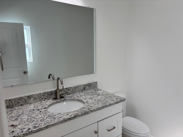 bathroom with toilet and vanity