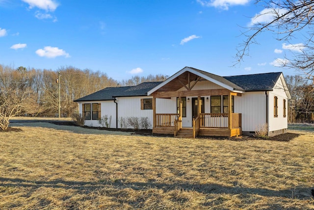 view of front of house featuring roof with shingles, a porch, crawl space, and a front yard