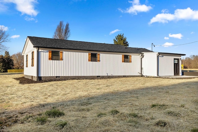 exterior space with crawl space and a lawn