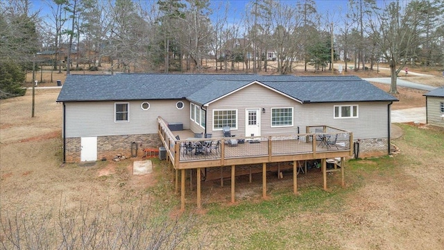 rear view of house with roof with shingles, a lawn, a deck, and central air condition unit