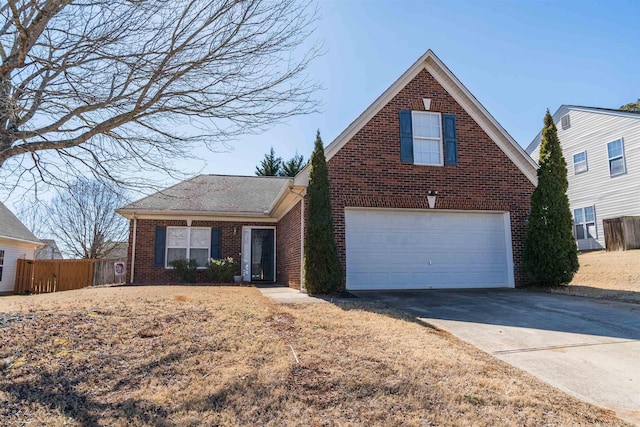 traditional-style home with concrete driveway, brick siding, fence, and an attached garage