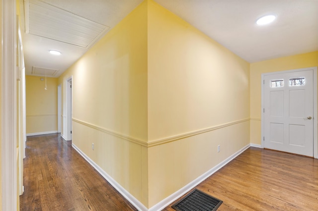 foyer with a wainscoted wall, visible vents, and wood finished floors