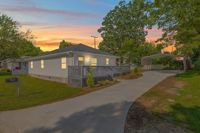 view of front of home featuring driveway, crawl space, a wooden deck, a front lawn, and a carport