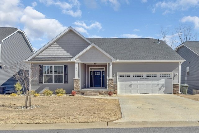 craftsman-style house featuring a standing seam roof, metal roof, a garage, stone siding, and driveway