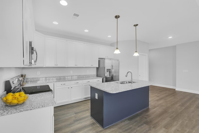 kitchen with white cabinets, a kitchen island with sink, stainless steel appliances, and a sink