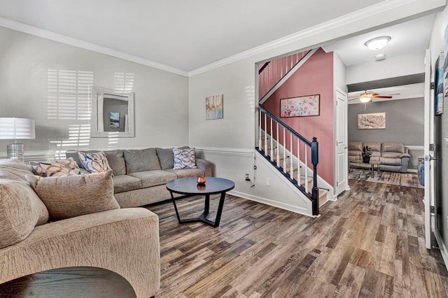 living room featuring stairs, wood finished floors, a ceiling fan, and crown molding