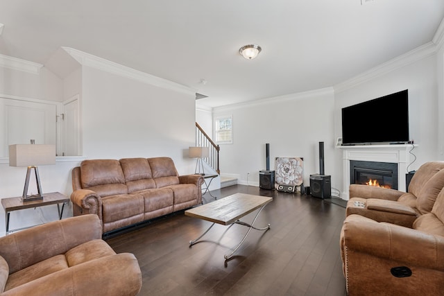 living room with dark wood-style floors, crown molding, baseboards, and stairs