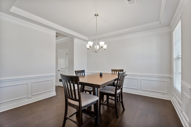 dining space featuring a chandelier, dark wood-style flooring, and ornamental molding