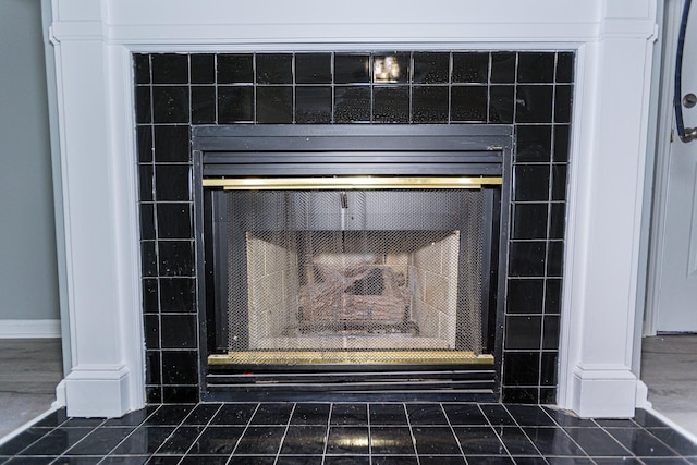 interior details with a tiled fireplace