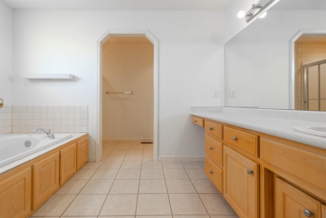 full bath with a garden tub, tile patterned flooring, vanity, baseboards, and a shower stall