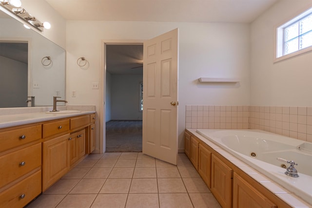 bathroom featuring vanity, a whirlpool tub, and tile patterned floors