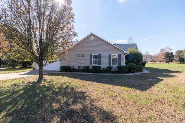 view of front facade with an attached garage, concrete driveway, and a front yard