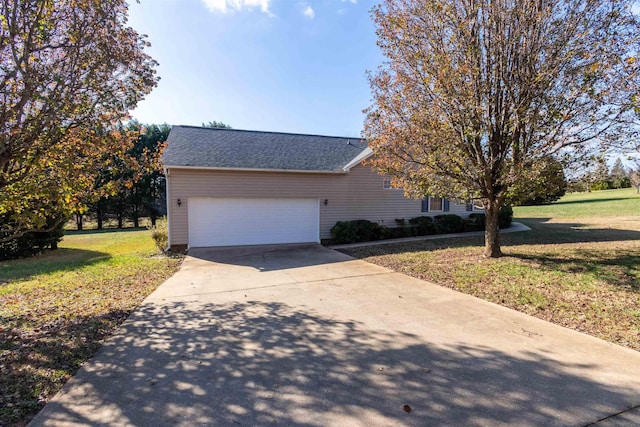 view of front facade with an attached garage, concrete driveway, and a front yard