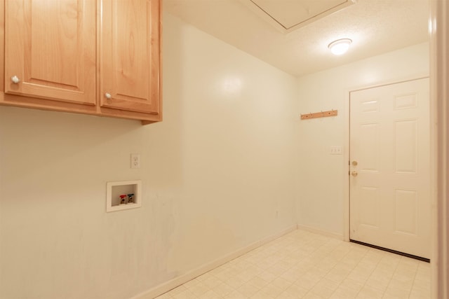 washroom with washer hookup, light floors, cabinet space, a textured ceiling, and baseboards