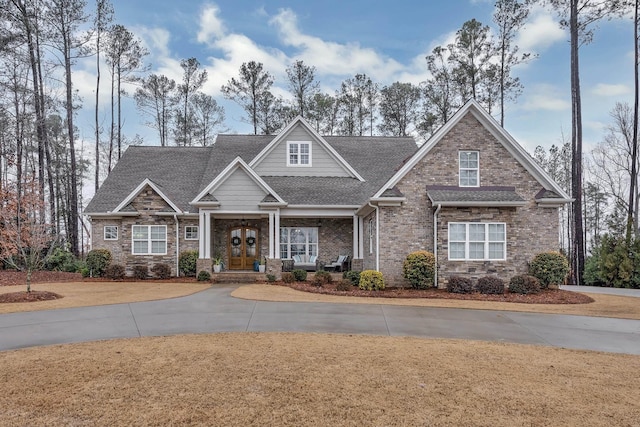 craftsman-style house with brick siding, roof with shingles, and a front yard