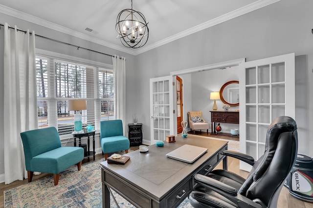 office with a chandelier, wood finished floors, visible vents, and crown molding