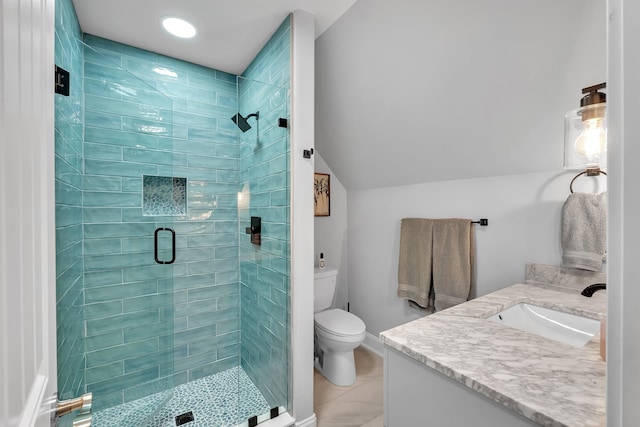 bathroom featuring toilet, tile patterned flooring, vaulted ceiling, vanity, and a shower stall