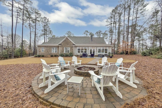 rear view of house featuring an outdoor fire pit and a patio