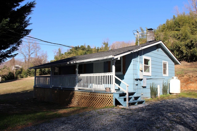 view of front of property with a porch and a chimney