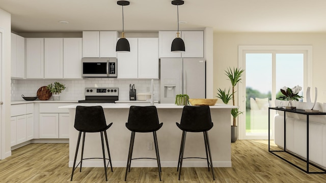 kitchen featuring white cabinets, appliances with stainless steel finishes, a center island, hanging light fixtures, and light countertops