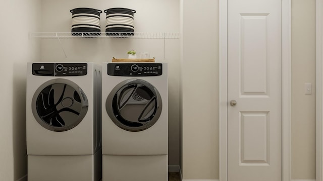 clothes washing area featuring laundry area and separate washer and dryer