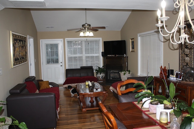 living room with lofted ceiling, a ceiling fan, visible vents, and wood finished floors