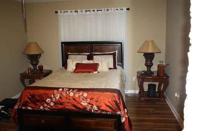 bedroom featuring wood finished floors and baseboards