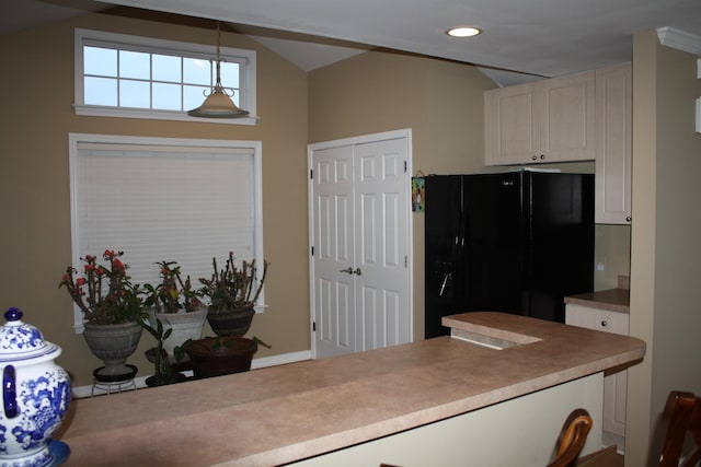 kitchen with recessed lighting, hanging light fixtures, freestanding refrigerator, white cabinets, and vaulted ceiling