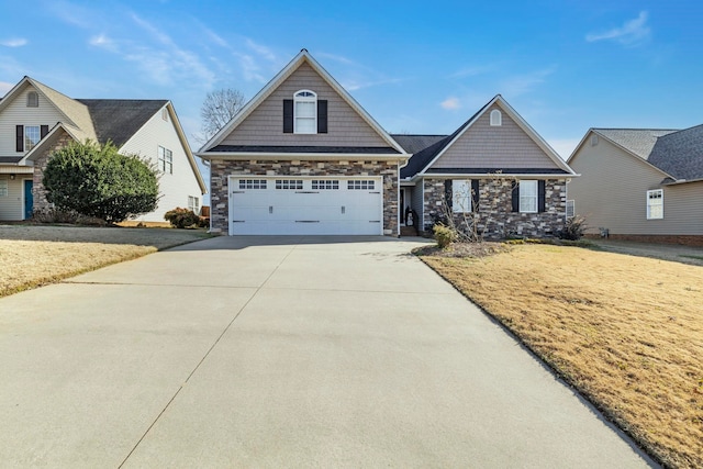 view of front of house with a garage, stone siding, driveway, and a front lawn