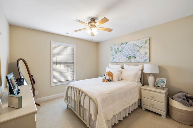 bedroom featuring light carpet, ceiling fan, visible vents, and baseboards