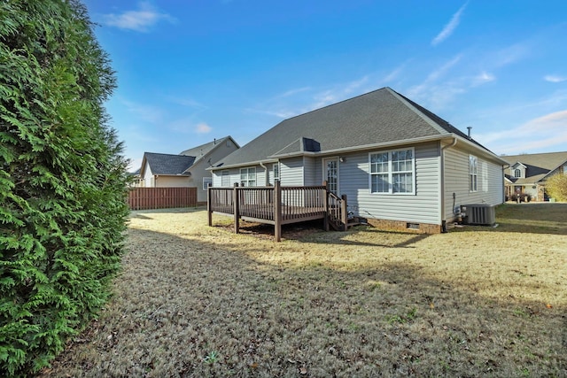 back of property featuring a lawn, crawl space, fence, a deck, and central air condition unit