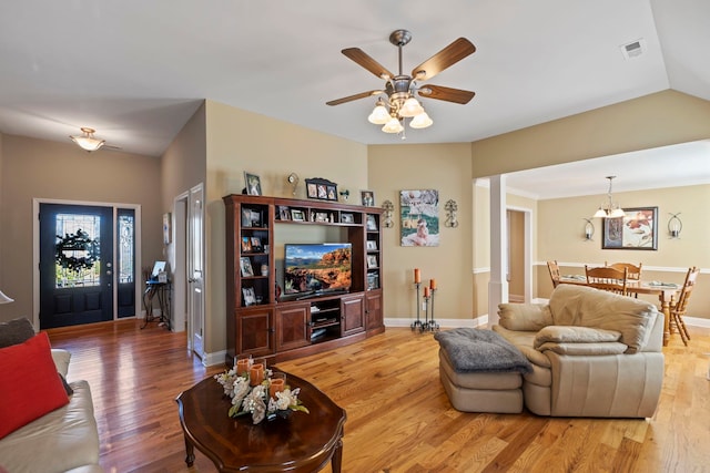 living area with visible vents, ceiling fan, baseboards, and wood finished floors